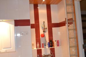 a bathroom with a red and white striped wall at House Olkka by the river in Rovaniemi