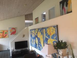 a living room with a painting on the wall at Spinkebjerg 18, 7400 Herning in Herning