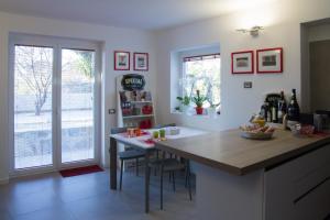 a kitchen with a counter and a table with chairs at Al dolce eremo in Trieste