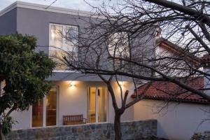 a house with a tree in front of it at Al dolce eremo in Trieste