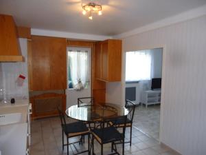 a kitchen with a table and chairs in a room at gite victoria in La Pommeraie-sur-Sèvre
