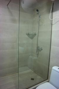 una doccia con porta in vetro accanto a servizi igienici di Gudauri Hotel Loft Apartment 323 a Gudauri