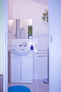 a white bathroom with a sink and a mirror at Privat No. 40 in Telč