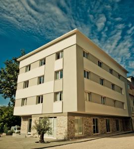a large white building with a sky in the background at Wine Hotel Cesarica in Međugorje
