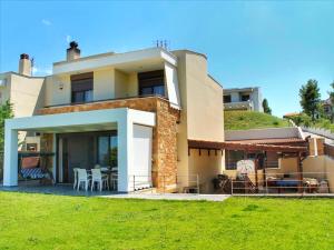 a large house with a lawn in front of it at Villa Rossa in Hanioti