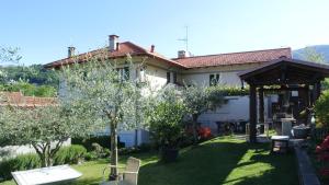 a house with a garden with trees in the yard at Al Rost B&B in Luino