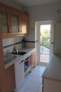a kitchen with a sink and a stove at Pl Les Bovetes Apt in Denia
