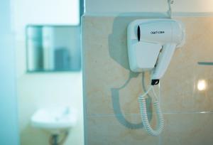 a phone is hanging on a wall in a bathroom at SingVillage Holiday House in Mersing +24 photos