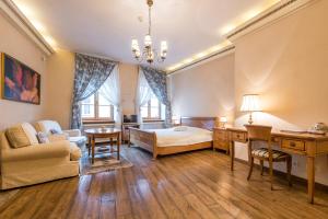 a bedroom with a bed and a desk in a room at Angel House Vilnius, Pilies in Vilnius