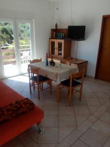 a kitchen with a table and chairs in a room at Apartments Irena in Božava