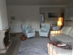 a living room with a couch and two chairs at SolTroia Glamorous Apartament in Troia