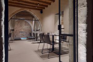 a dining room with a long table and chairs at Monastery Estate Venetian Harbor in Chania