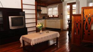 a kitchen with a table with a vase of flowers on it at Hotel Laguna in Bocas Town