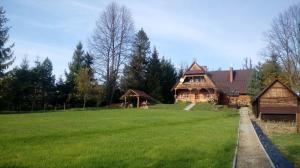 a large house with a large lawn in front of it at Miętowy Anioł in Ustrzyki Dolne