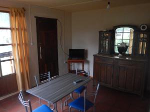 a dining room with a wooden table and chairs at Jujuy Casa Pueblo in Reyes