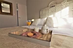 a tray with cookies and drinks on a bed at Sun And Chic Malaga in Málaga
