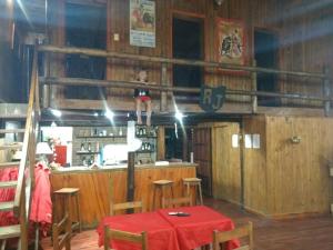 a little girl is sitting on top of a bar at Bungalows Maneyros in Gualeguaychú