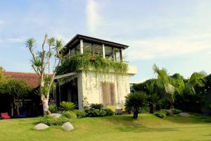 a house with a lot of plants on it at Holiday beautiful Villa 4 Bedroom Garden View Canggu in Canggu