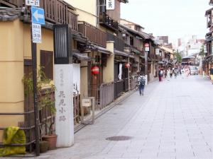 a city street with people walking down the street at Kyoto Inn Gion The Second in Kyoto