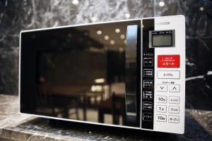 a microwave oven sitting on top of a counter at Toho Hotel in Osaka