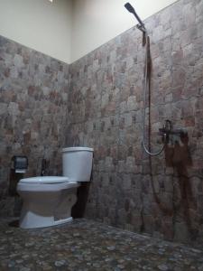 a bathroom with a toilet and a shower at Doeloerkoe Homestay in Solo