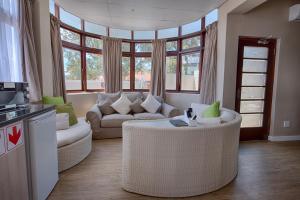 a living room with a couch and a table at A&A Guesthouse in Port Elizabeth