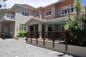 a house with a balcony in front of it at A&A Guesthouse in Port Elizabeth