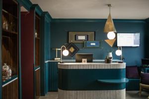 a blue room with a counter with lights on it at ibis Styles Paris Nation Cours de Vincennes in Paris
