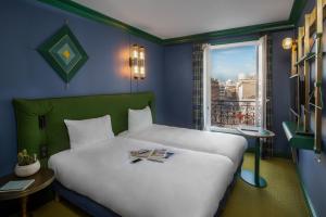 a bedroom with a white bed with a window at ibis Styles Paris Nation Cours de Vincennes in Paris
