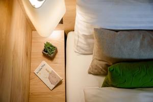 a bedroom with a bed with a night stand and a plant on a table at EVA Serviced Apartments in Zermatt