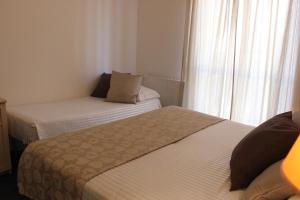 Postel nebo postele na pokoji v ubytování Hotel Miramare