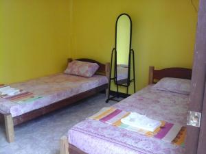 A bed or beds in a room at Xylla Guesthouse