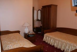 a hotel room with two beds and a mirror at Nelly Apart in Kyiv