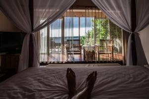 a person laying on a bed with their feet on the bed at Summer Ya B&B in Huxi