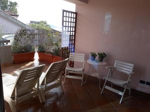 a patio with chairs and a table on a balcony at B&B Villa Noemi in Formia