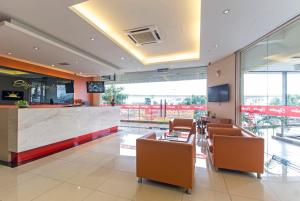 a lobby with chairs and a bar in a building at Signature Hotel @ Puchong Setiawalk in Puchong