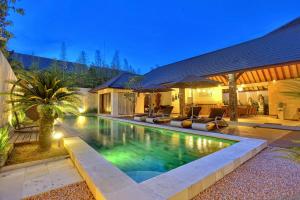 a swimming pool in the backyard of a house at Villa Esperanto Seminyak in Seminyak