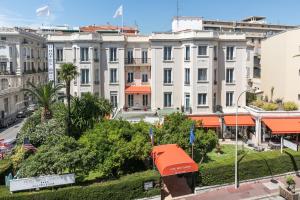 a large white building with orange roofs in a city at Best Western Plus Hôtel Brice Garden Nice in Nice