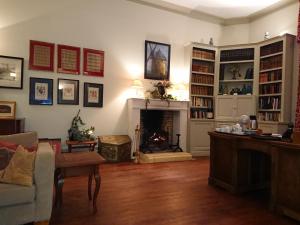 a living room with a fireplace and a fire place at Château Le Tour - Chambres d'Hôtes in Faux