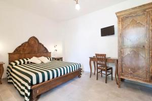 a bedroom with a bed and a desk and a chair at Agriturismo Fontanelle in Otranto
