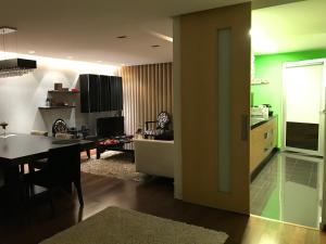a kitchen and living room with a table and a dining room at Dream Space Home in Leiria