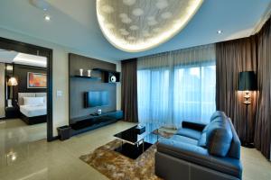 un soggiorno con divano blu e letto di The Prestige Nana a Bangkok