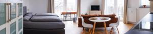 a living room with a bed and a table and chairs at Villa am Wall in Osnabrück