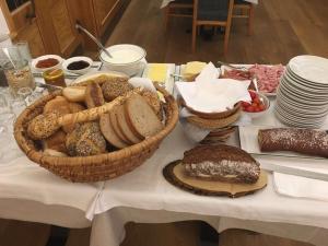 a table topped with baskets of bread and other foods at Gasthof Waldschenke in Bad Leonfelden