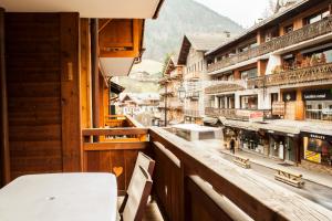 a balcony of a building with a view of a town at Slemish Apt in Morzine