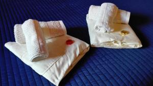 two towels sitting on top of a bed at B&B da mamma Lo in Tolmezzo +46 photos