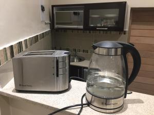 a blender sitting on a counter next to a toaster at Villa MikaMora in Johannesburg