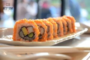 a plate of sushi sitting on a table at Best Stay Hostel At Lanta in Ko Lanta