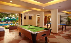 a pool table in a living room with a pool table at Turtle Beach Resort - Morjim in Morjim