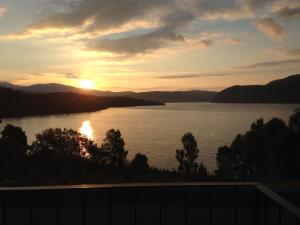 a sunset over a large body of water at Pammy's Family Annexe EXCLUSIVE USE in Garve